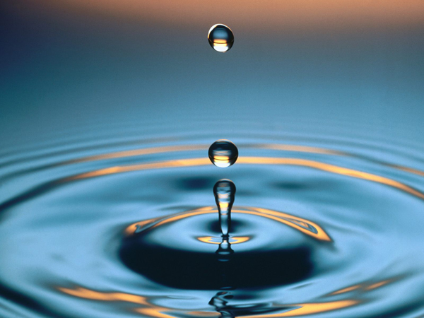 A water droplet creating radiating ripples